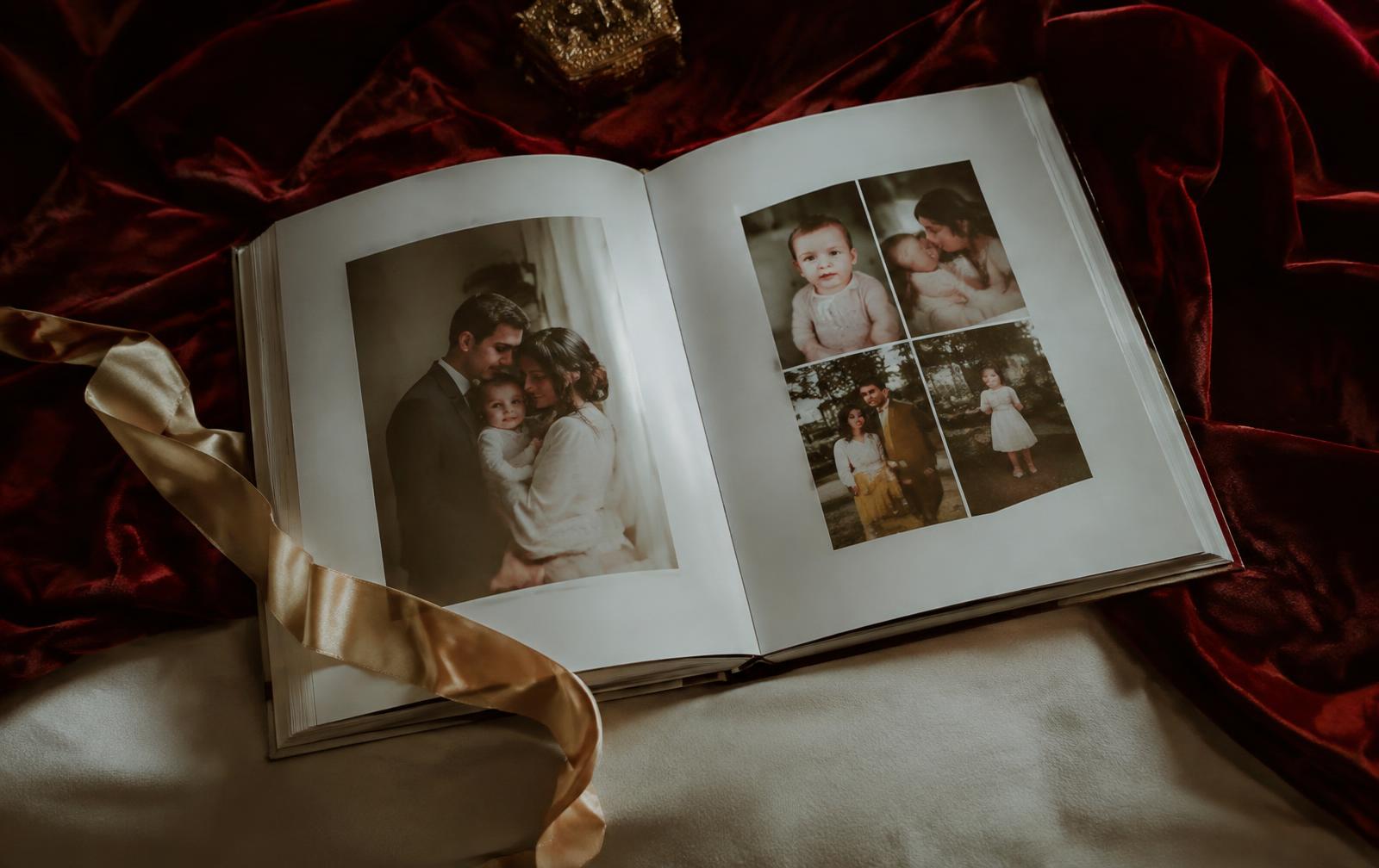 Open hardcover photobook on burgundy velvet
